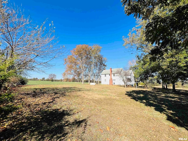 view of yard with a rural view