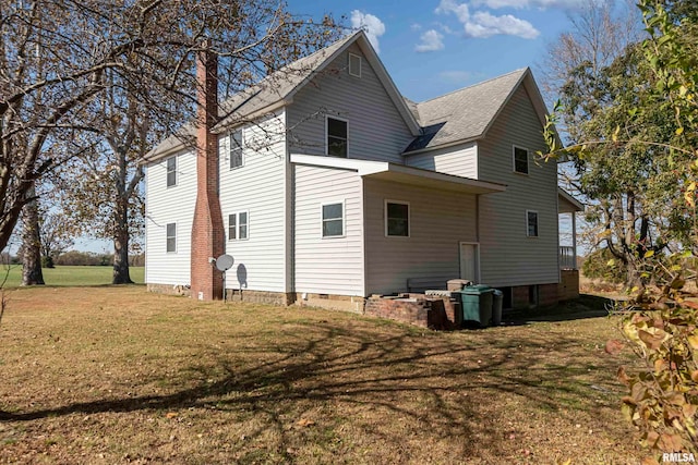 rear view of house featuring a lawn