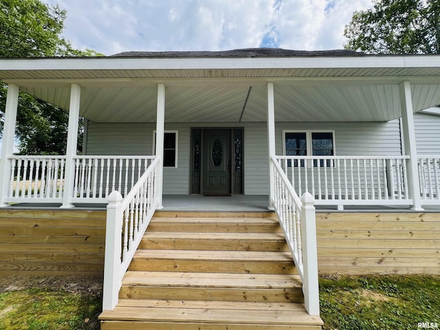 entrance to property featuring a porch