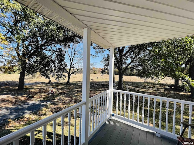 wooden deck with a rural view