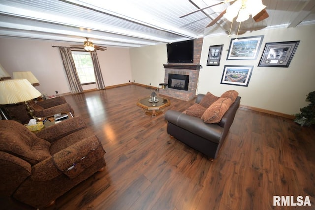 living room with beam ceiling, dark hardwood / wood-style flooring, and a fireplace