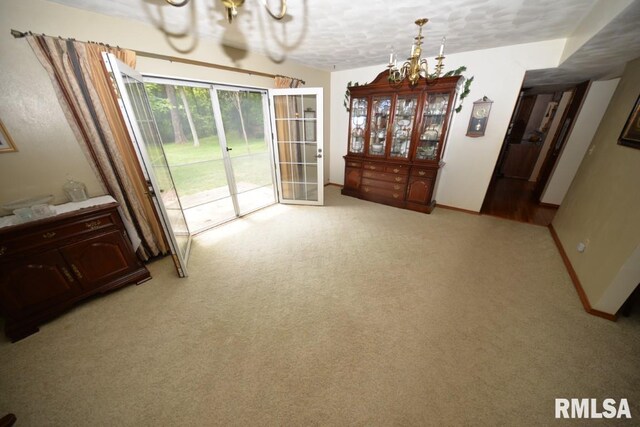 dining space with carpet and a textured ceiling