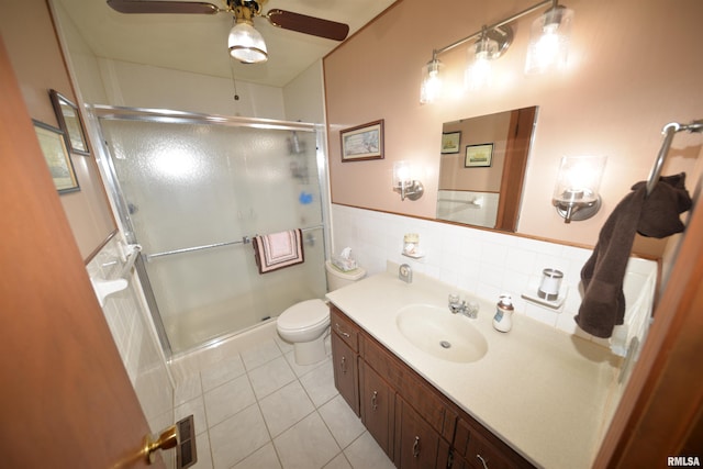 bathroom with tile patterned flooring, ceiling fan, a shower with shower door, and vanity