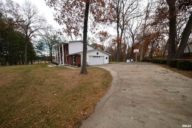 view of property exterior with a garage and a yard