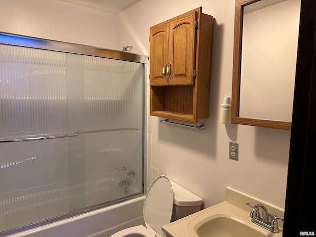 full bathroom with vanity, toilet, and bath / shower combo with glass door