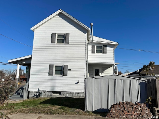 view of home's exterior with a storage shed