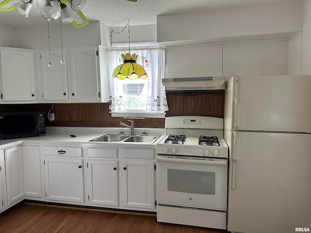 kitchen featuring a textured ceiling, white appliances, dark wood-type flooring, sink, and white cabinetry