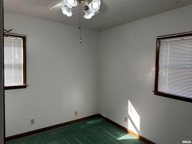 unfurnished room with ceiling fan, a textured ceiling, and dark colored carpet