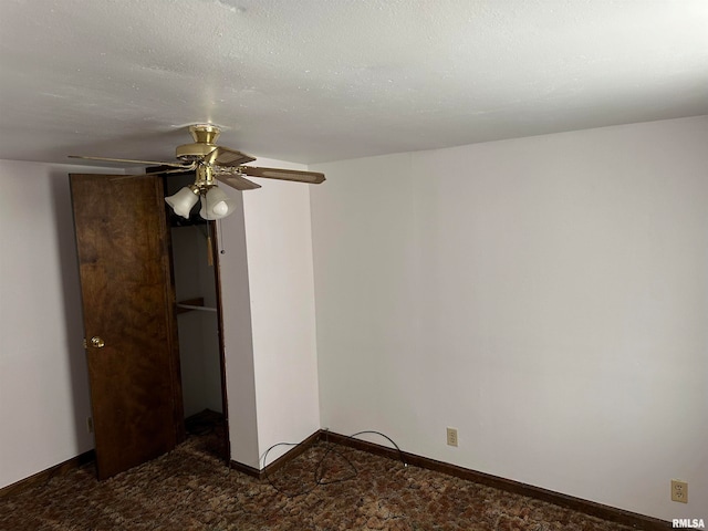 unfurnished bedroom with ceiling fan, a textured ceiling, and dark colored carpet