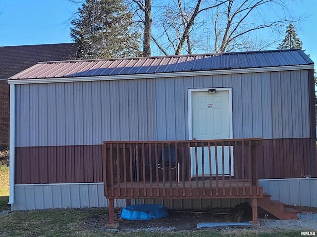 view of property exterior with a wooden deck