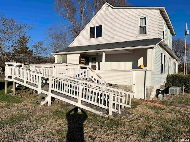 view of front of home with central air condition unit and a wooden deck