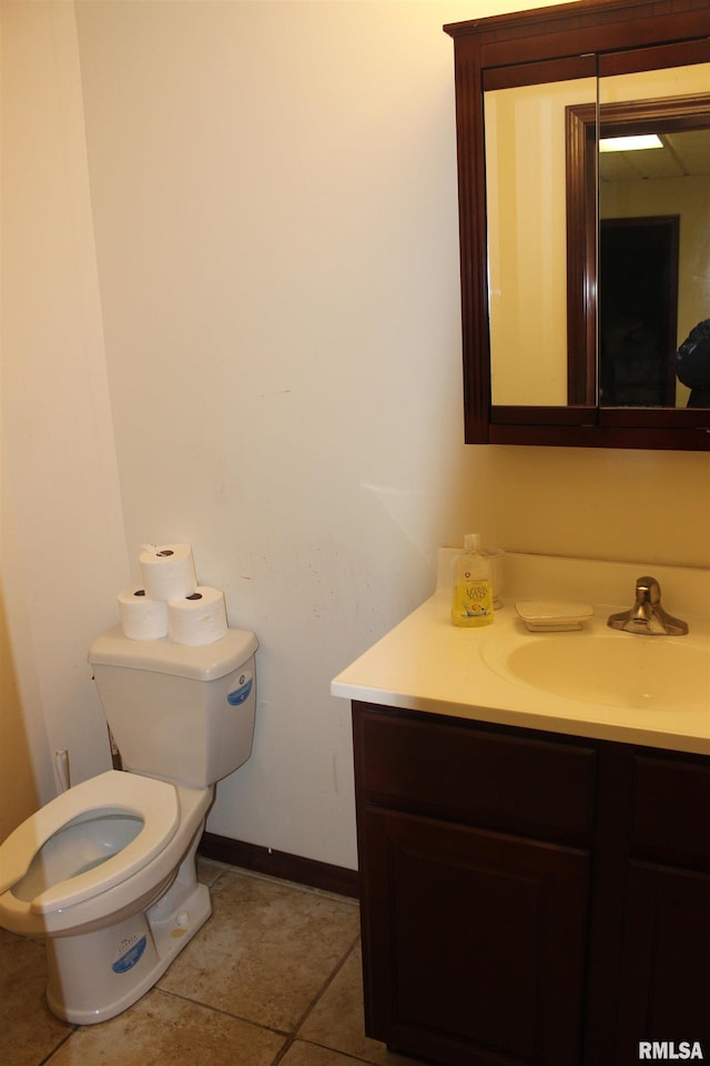 bathroom with vanity, tile patterned floors, and toilet