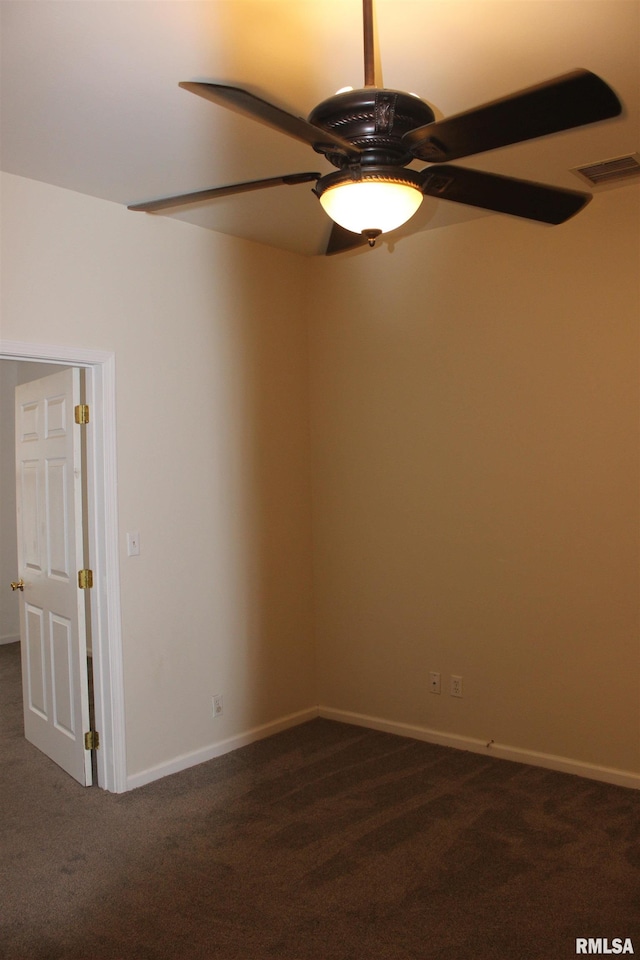 unfurnished room with dark carpet and ceiling fan