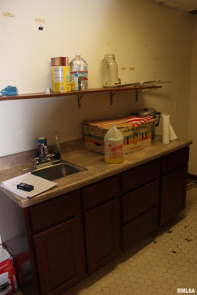 kitchen featuring dark brown cabinetry and sink