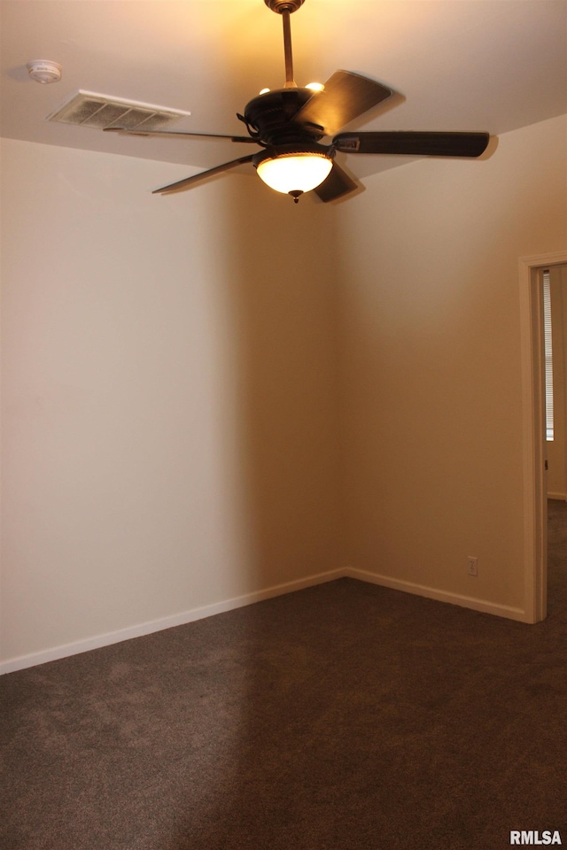 unfurnished room featuring ceiling fan and dark carpet