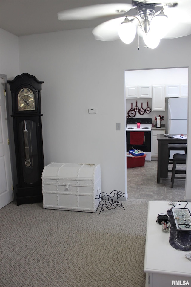 carpeted bedroom with ceiling fan and white fridge