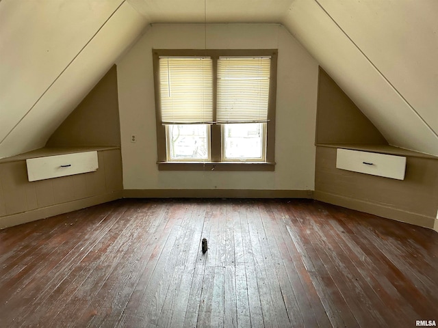 bonus room featuring dark hardwood / wood-style floors and vaulted ceiling
