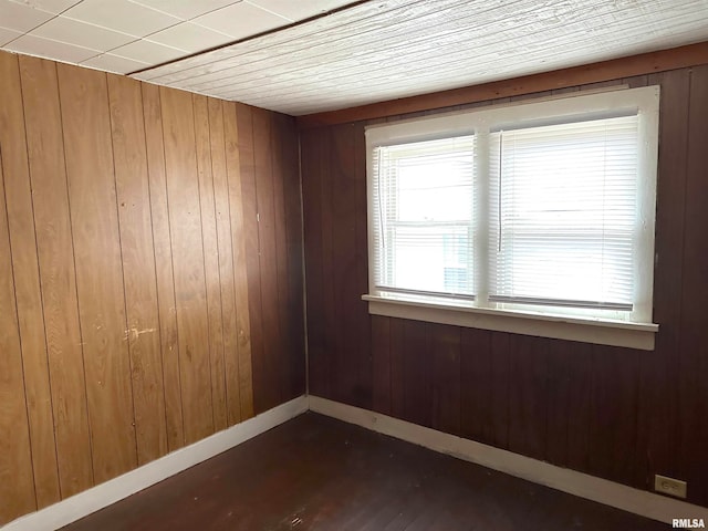 empty room featuring wood walls