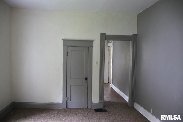 empty room with dark carpet
