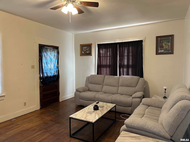 living room featuring dark hardwood / wood-style flooring and ceiling fan