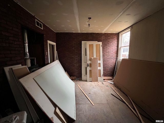 miscellaneous room featuring brick wall