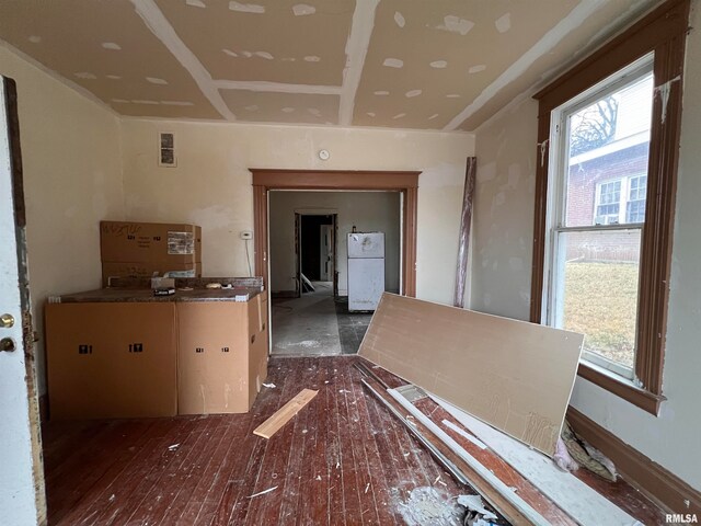 interior space featuring plenty of natural light, white refrigerator, and dark hardwood / wood-style flooring