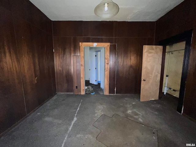 spare room featuring wood walls