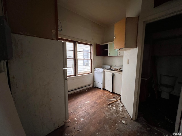 kitchen featuring dark hardwood / wood-style flooring, separate washer and dryer, and a baseboard heating unit