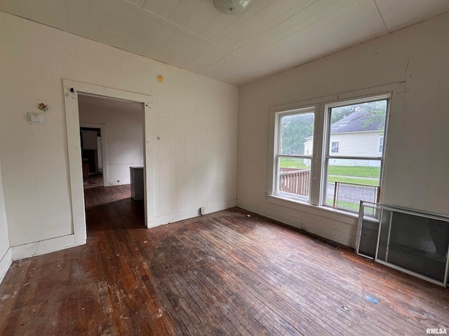 unfurnished room with wooden ceiling and dark hardwood / wood-style flooring