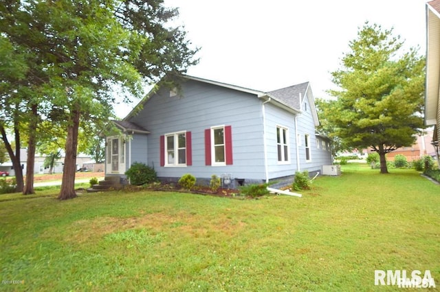 view of home's exterior with a lawn