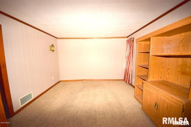 carpeted spare room featuring crown molding