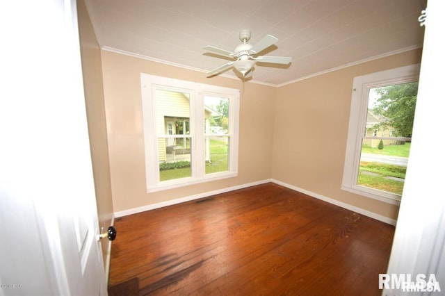 empty room with crown molding, ceiling fan, and dark hardwood / wood-style flooring