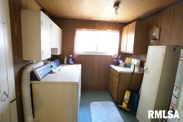 laundry room featuring independent washer and dryer, wood ceiling, cabinets, wood walls, and light colored carpet