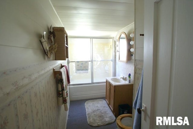 full bathroom with bath / shower combo with glass door, vanity, and toilet