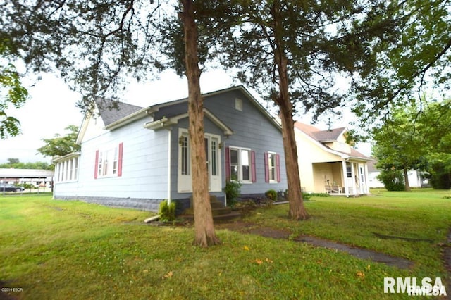 view of side of property with a yard