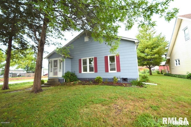 rear view of house with a lawn