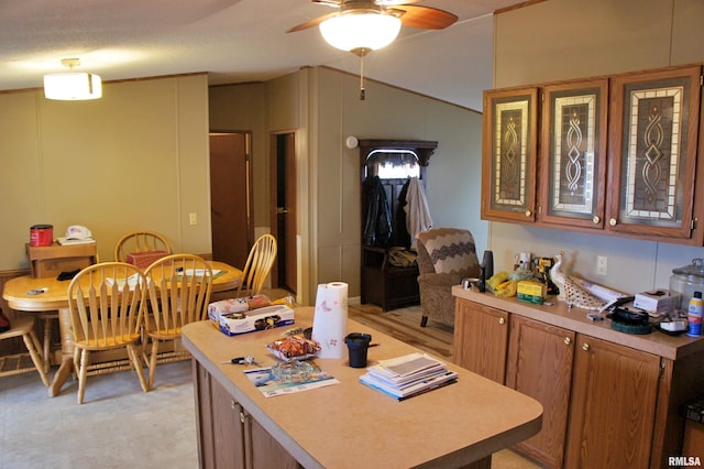 kitchen featuring ceiling fan and light carpet