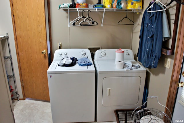 washroom with hookup for a washing machine, separate washer and dryer, and light tile floors