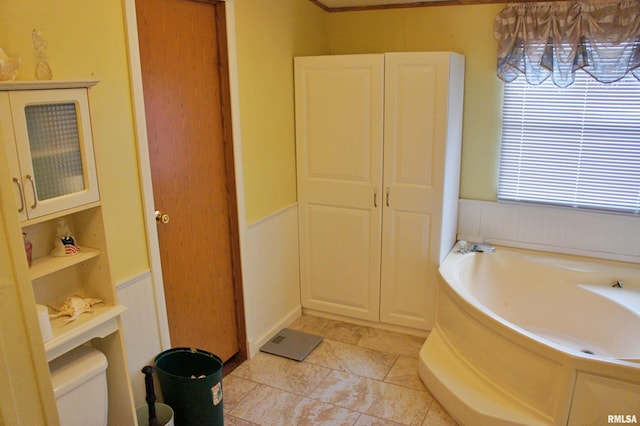 bathroom featuring tile flooring, a bathtub, and toilet