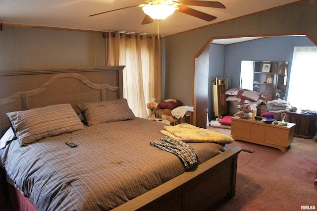 bedroom with ceiling fan and dark colored carpet