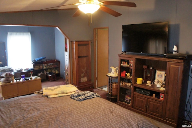 bedroom featuring ceiling fan, lofted ceiling, and dark colored carpet