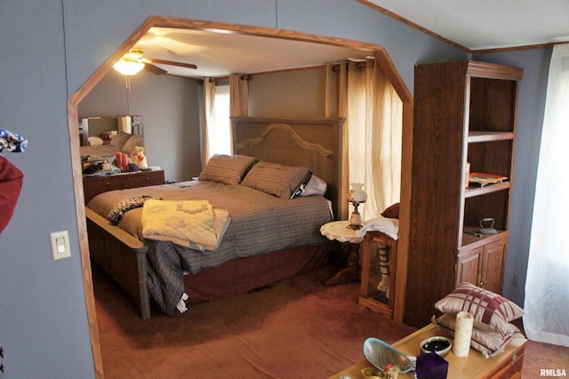 carpeted bedroom with ceiling fan and crown molding