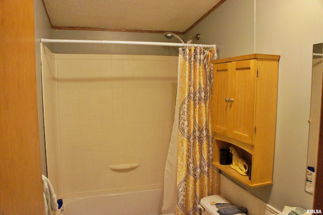 bathroom featuring a textured ceiling, toilet, and shower / bath combo with shower curtain