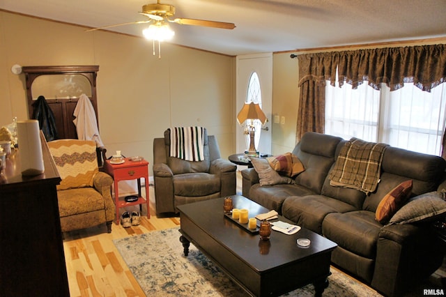 living room featuring ceiling fan and light wood-type flooring