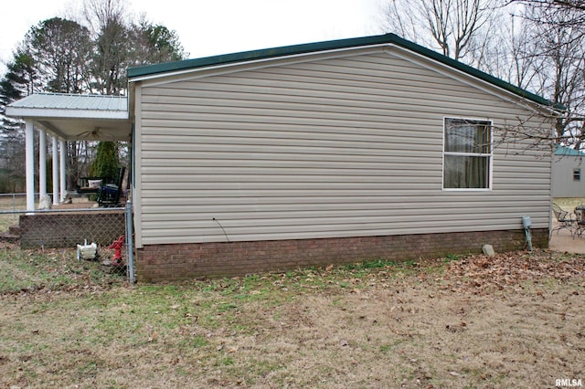 view of side of home featuring ceiling fan and a patio area