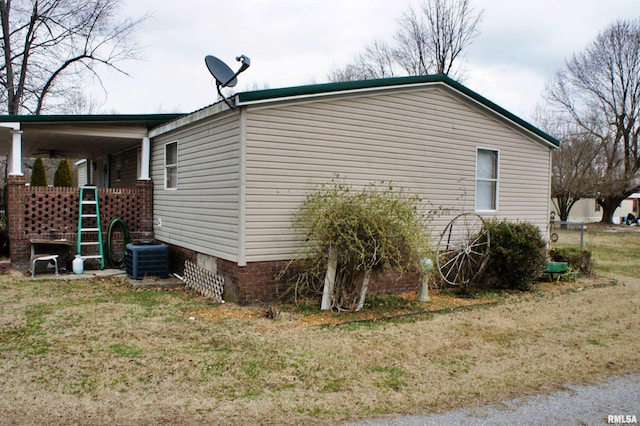 view of home's exterior featuring central air condition unit and a lawn