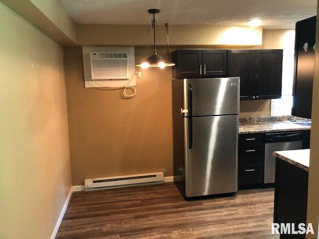 kitchen featuring pendant lighting, a wall unit AC, light hardwood / wood-style flooring, a baseboard radiator, and appliances with stainless steel finishes