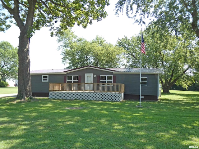 rear view of property with a yard and a wooden deck