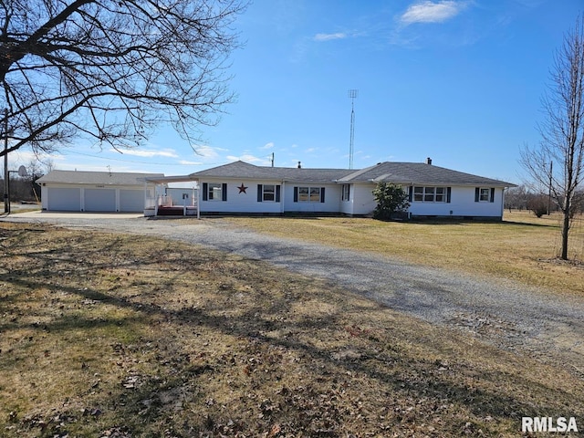 single story home with a garage and a front lawn