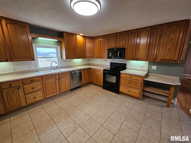 kitchen with sink, light tile patterned floors, backsplash, black appliances, and a textured ceiling